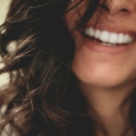 Woman with a bright smile after professional teeth whitening in Avon, IN
