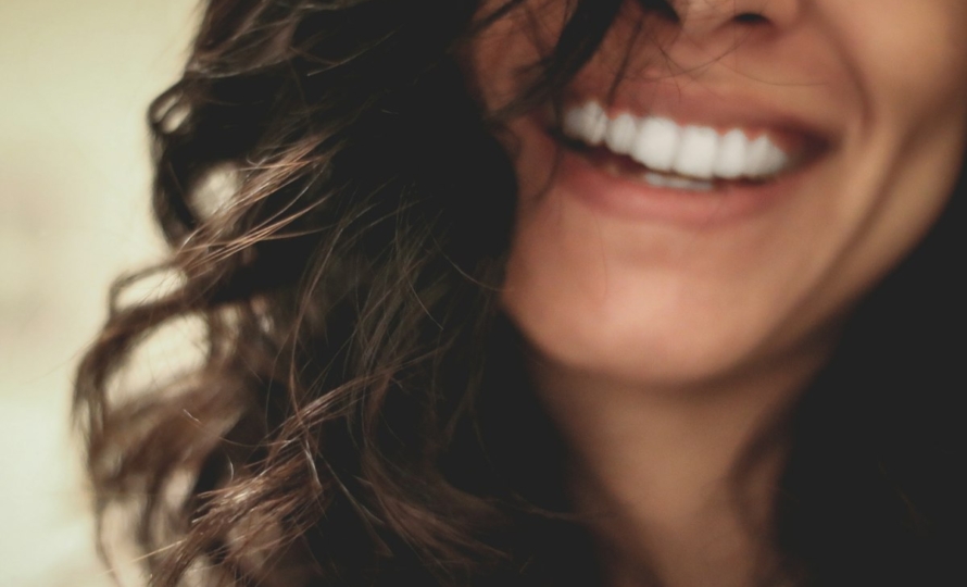 Woman with a bright smile after professional teeth whitening in Avon, IN
