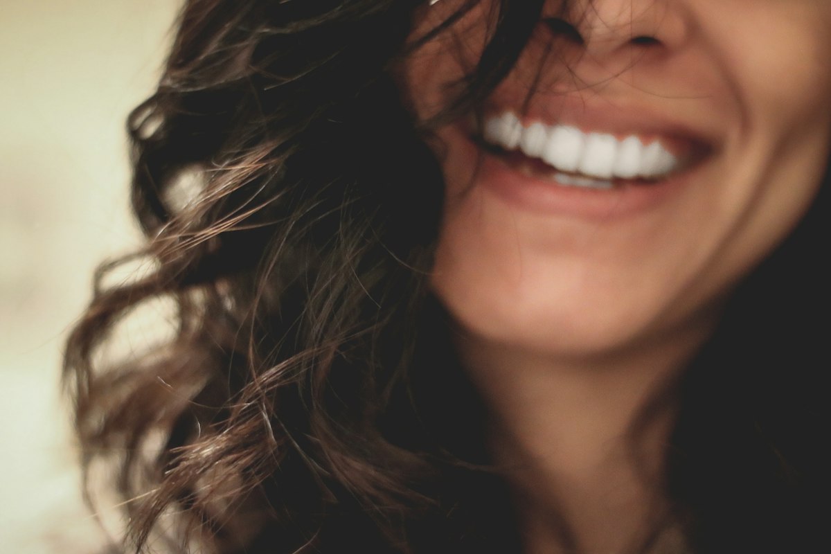 Woman with a bright smile after professional teeth whitening in Avon, IN
